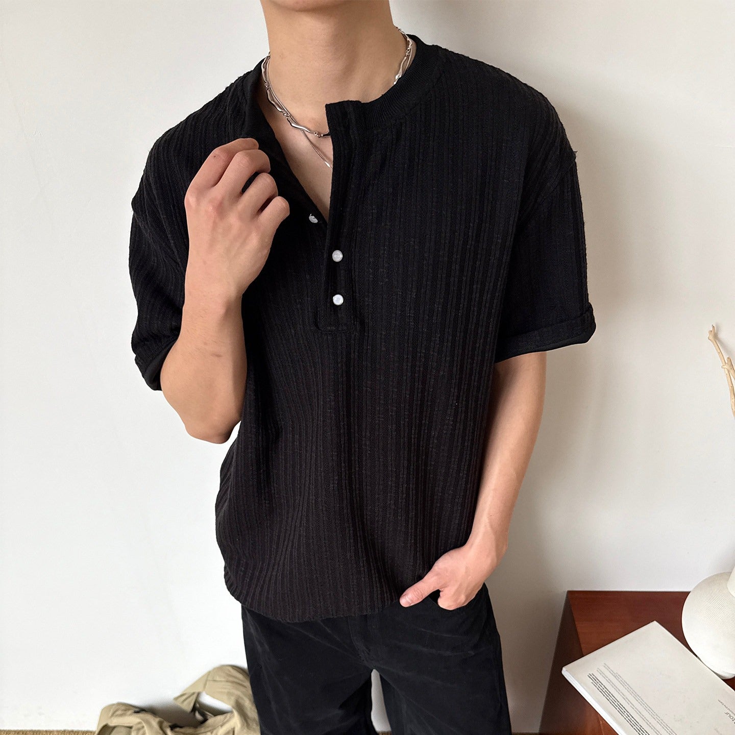 Black men's retro knitted henley collar short sleeve t-shirt casual streetwear lifestyle shot TeenStylo