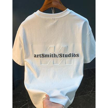 Man wearing white 3D embossed print short sleeve t-shirt streetwear style lifestyle shot TeenStylo
