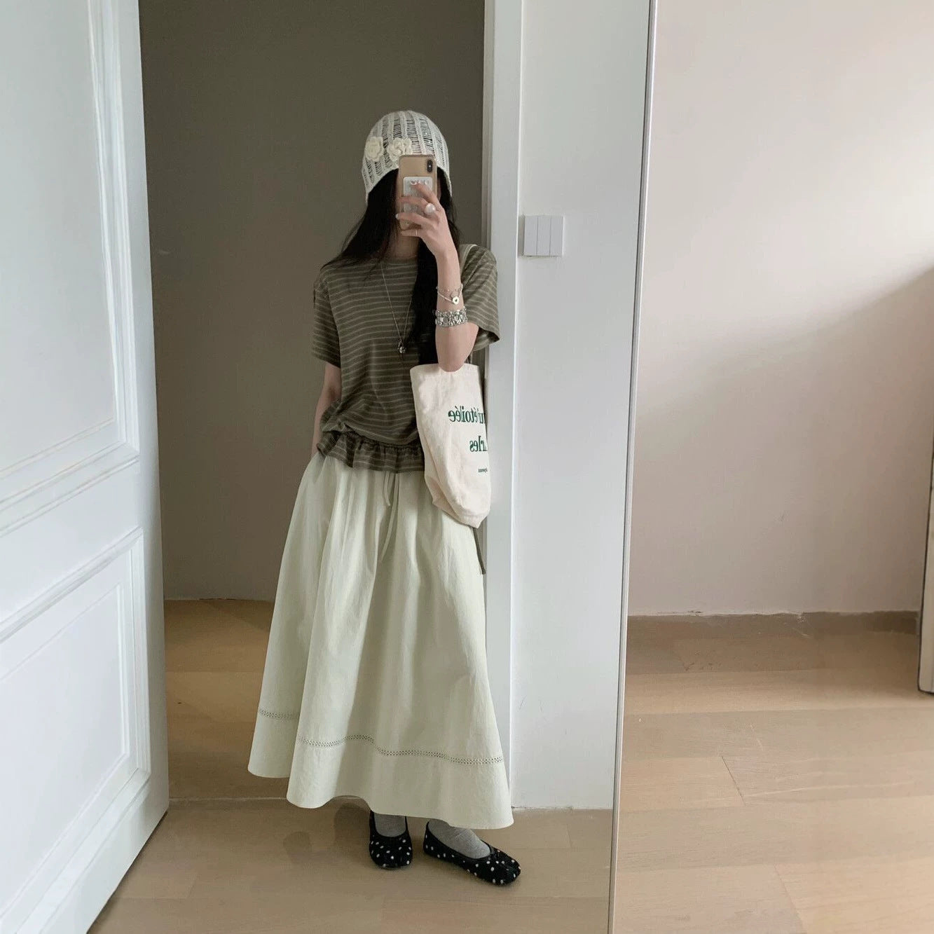 Woman wearing beige striped ruffled short sleeve t-shirt in casual lifestyle setting | TeenStylo