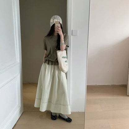 Woman wearing beige striped ruffled short sleeve t-shirt in casual lifestyle setting | TeenStylo