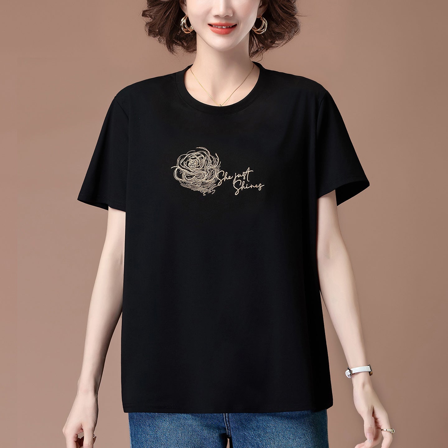 Black embroidered detail close-up on women's loose short sleeve T-shirt | TeenStylo