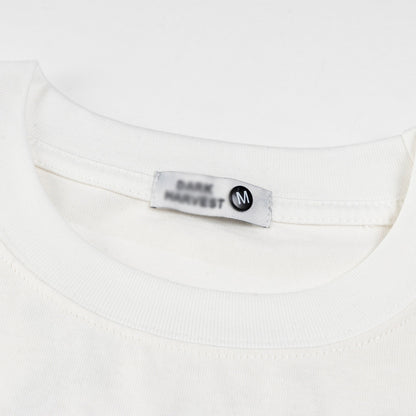 White floral letter embroidery detail on short sleeve shirt, Y2K streetwear style for men | TeenStylo
