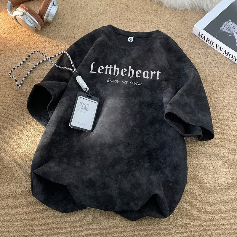 Man wearing black tie-dye short sleeve t-shirt in urban streetwear style | TeenStylo