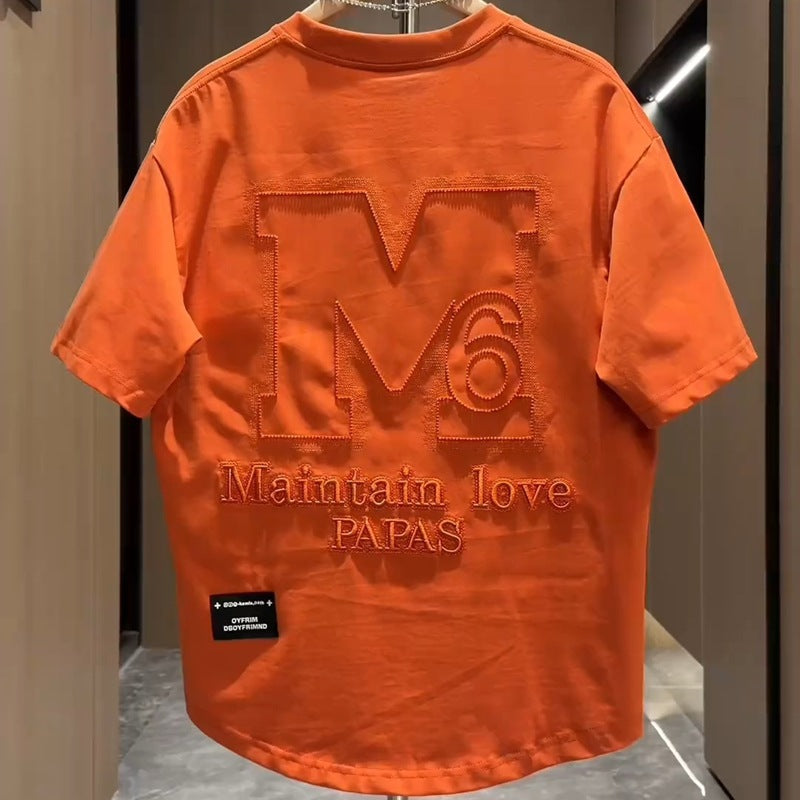 Orange men's designer letter M embroidered half sleeve top lifestyle shot TeenStylo
