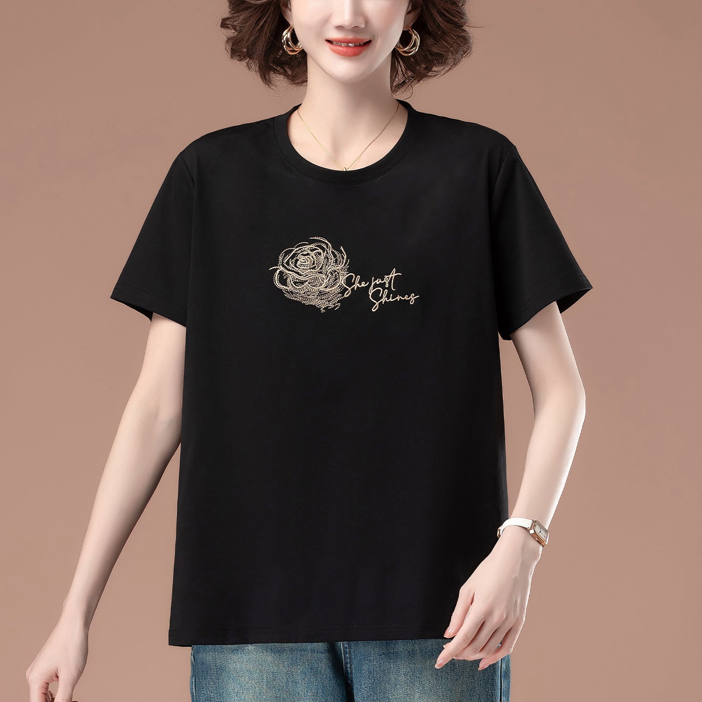 Black embroidered loose T-shirt worn in casual lifestyle setting, Y2K streetwear style unisex tee | TeenStylo