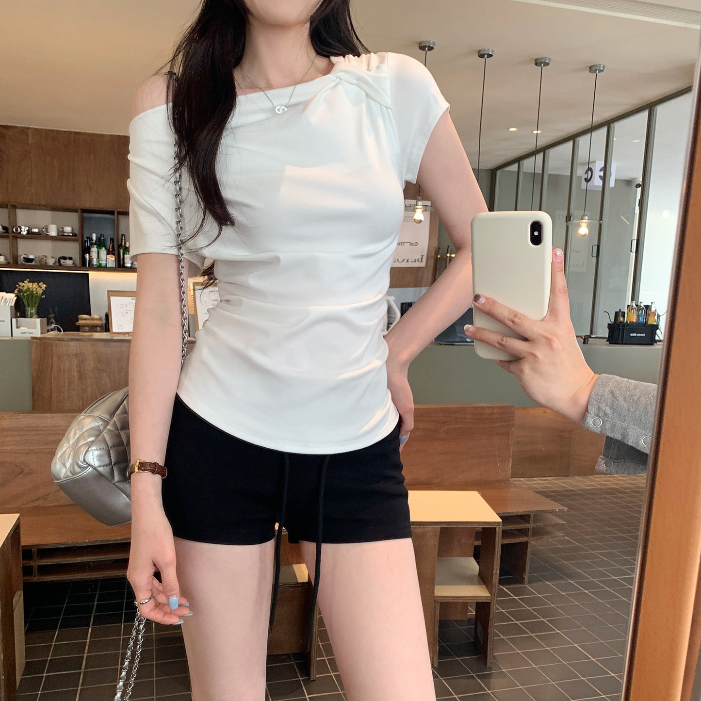 White off-shoulder sleeveless t-shirt fabric detail close-up, lightweight stretch material | TeenStylo