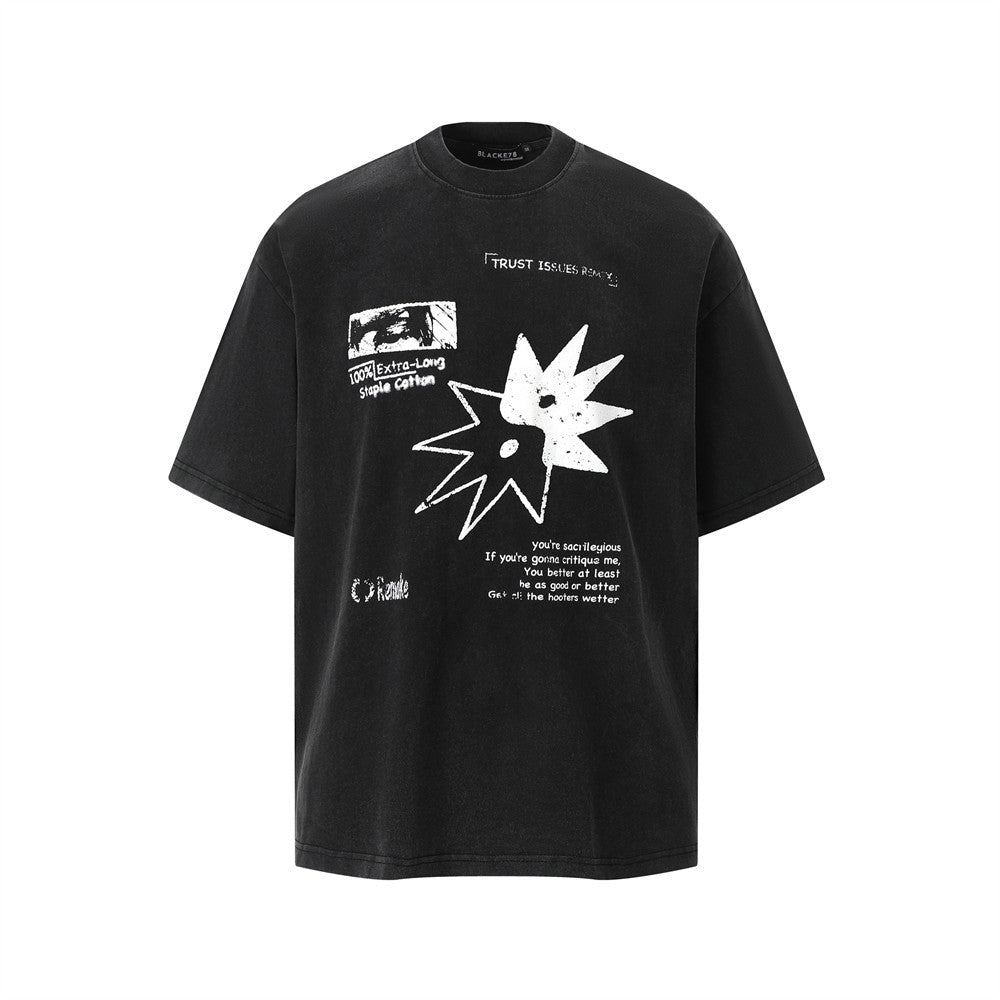 Man wearing aged black pattern printed faded washed short sleeve t-shirt in streetwear style at TeenStylo