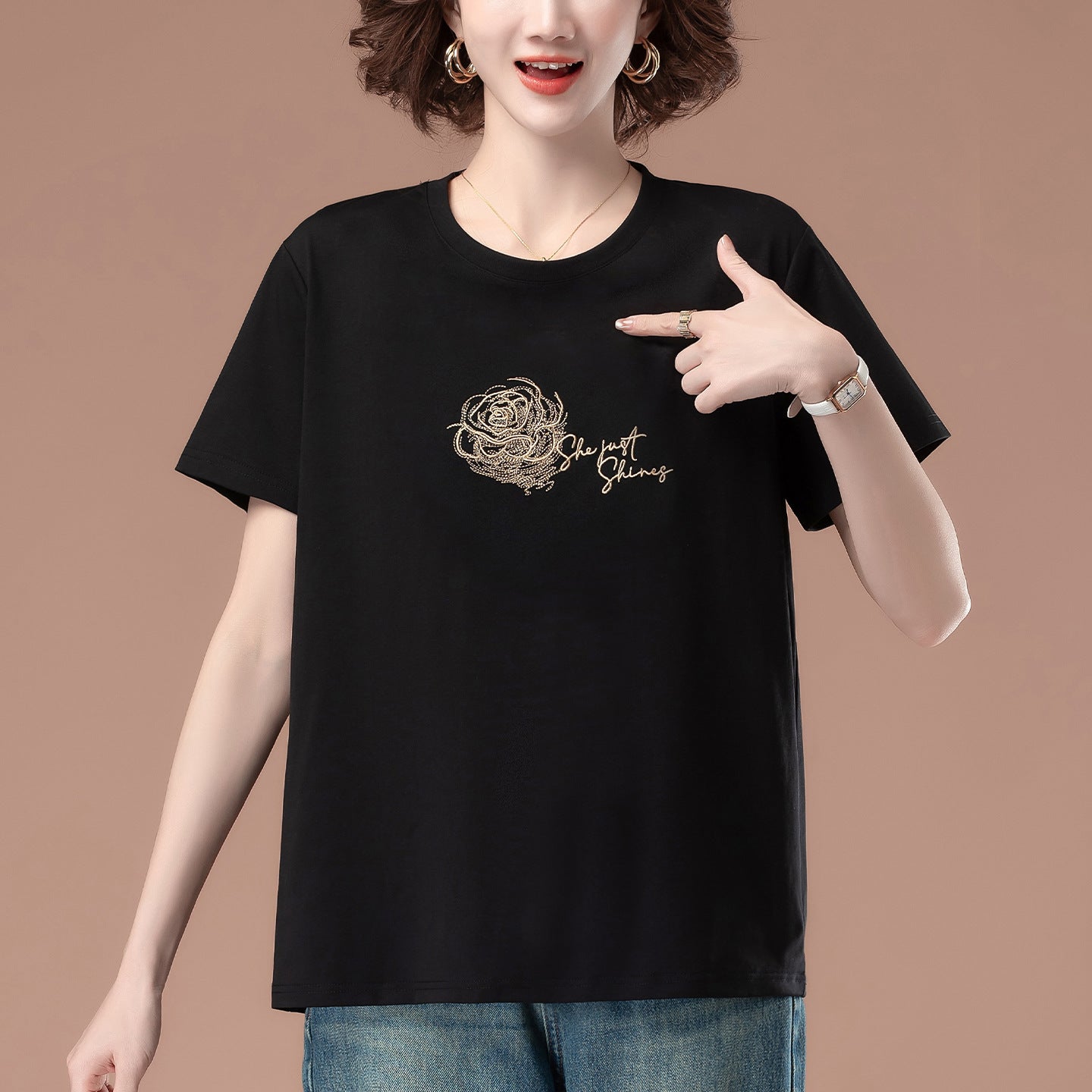 Black embroidered loose women's T-shirt back view, short sleeves, relaxed fit streetwear style | TeenStylo