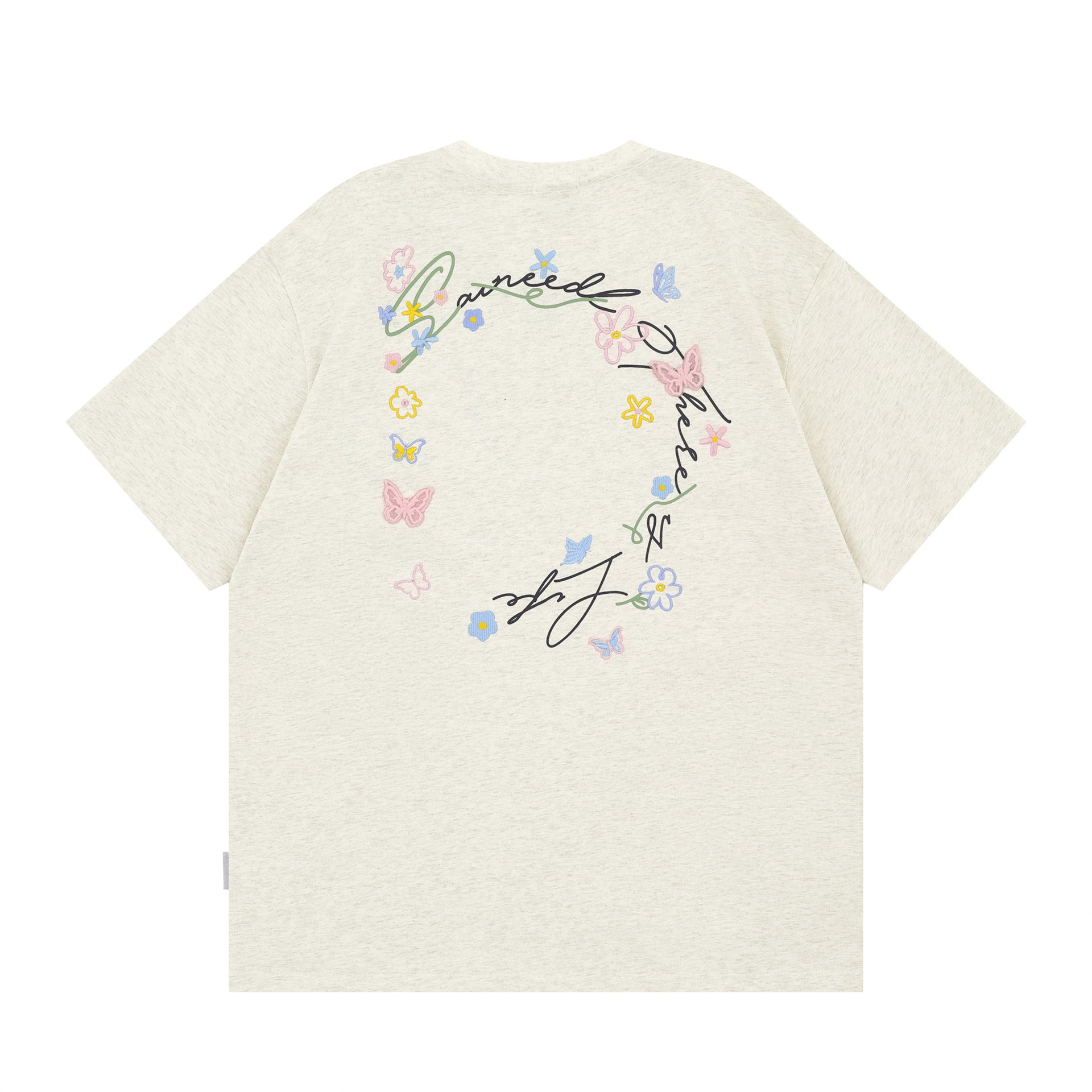 Black butterfly floral letter embroidery detail close-up on short sleeve tee - TeenStylo