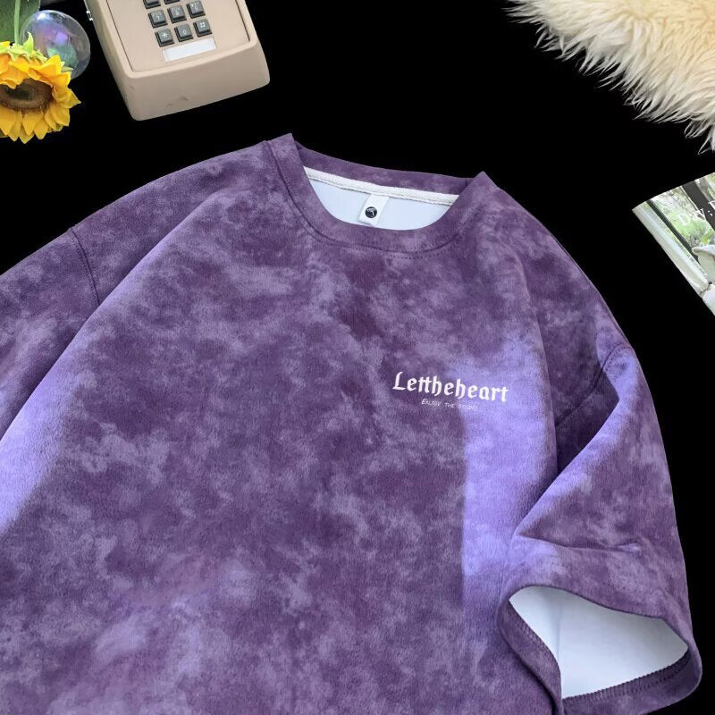 Man wearing purple tie-dye short sleeve t-shirt in streetwear style casual lifestyle look | TeenStylo