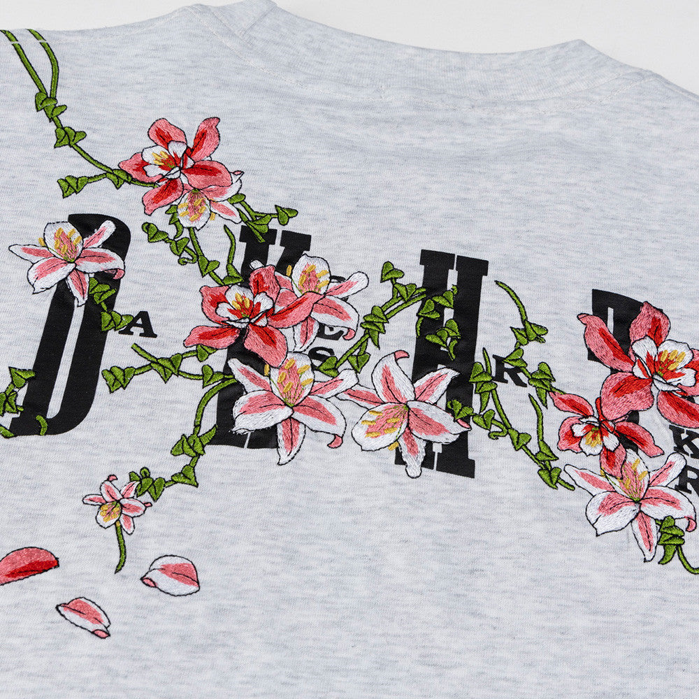 Teen wearing Snowflake Gray vine flower embroidery letter t-shirt in urban streetwear style | TeenStylo