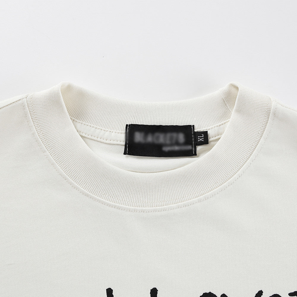 Milk apricot abstract figure print detail close-up on mens streetwear short sleeve tee TeenStylo