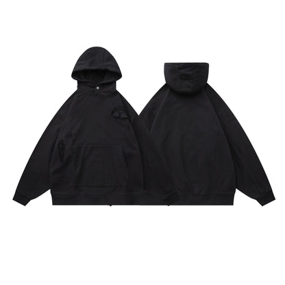 Black oversized hoodie patchwork detail close-up stitching texture streetwear gothic style TeenStylo
