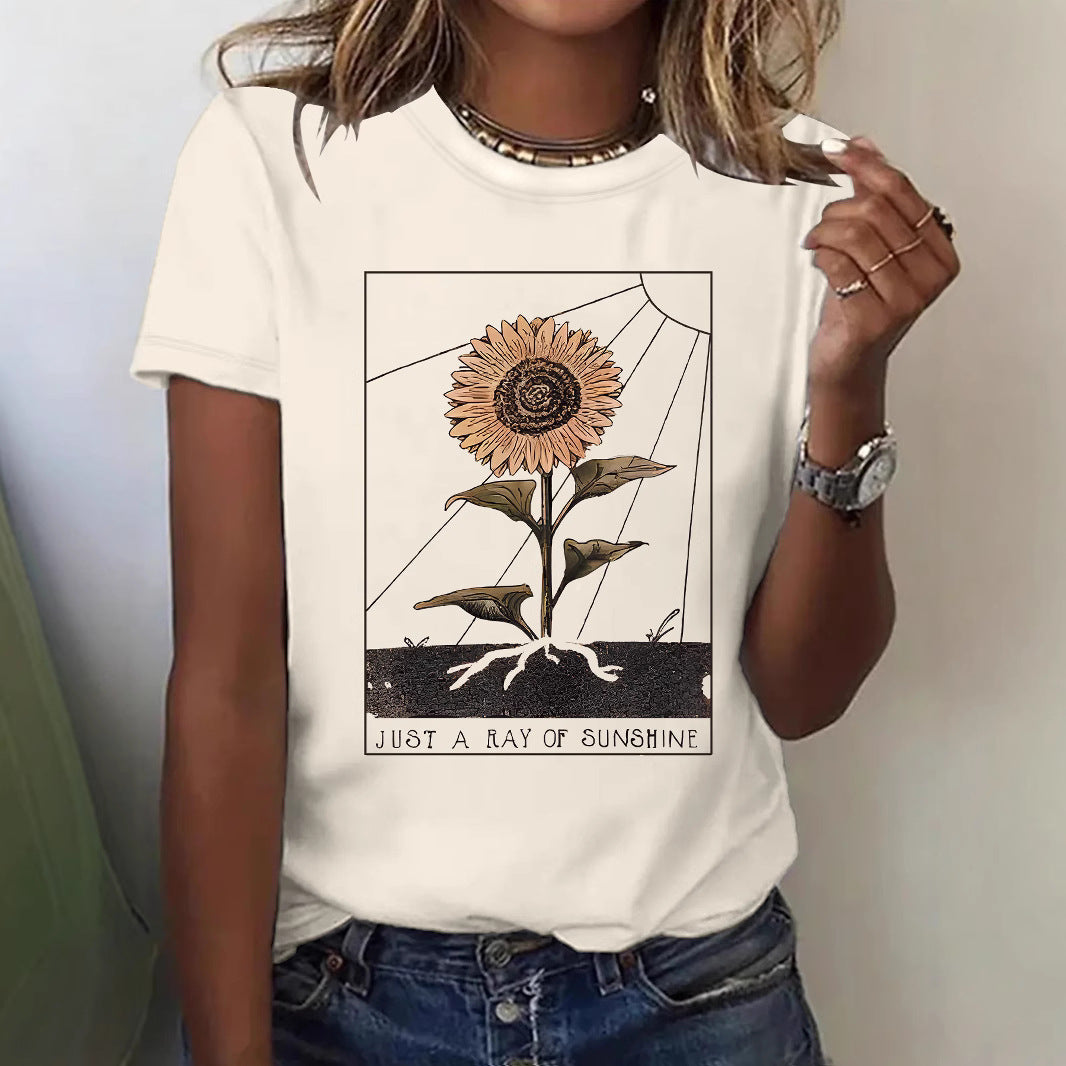 Woman wearing orange floral sunflower short sleeve T-shirt in lifestyle setting | TeenStylo