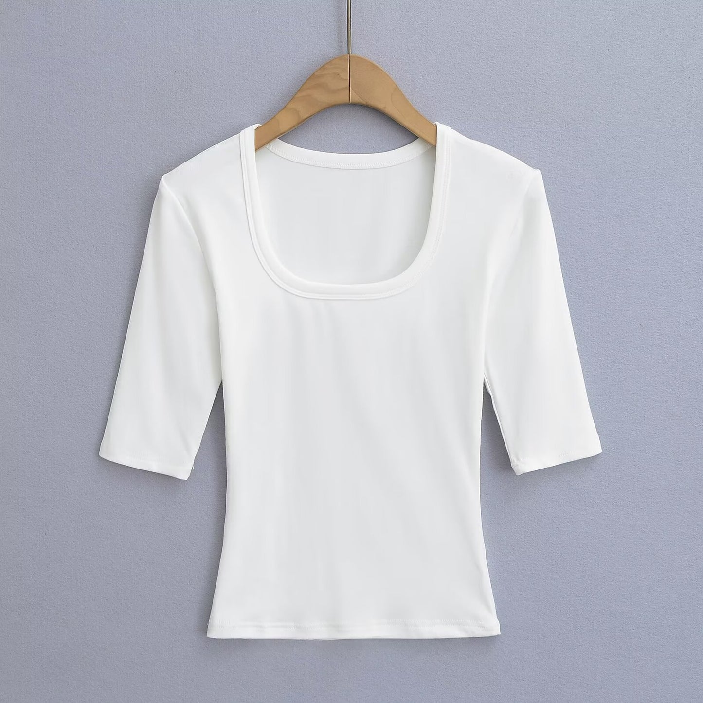 White unisex elastic fitted U-neck lockbone mid-sleeve tee styled casually, lifestyle shot | TeenStylo