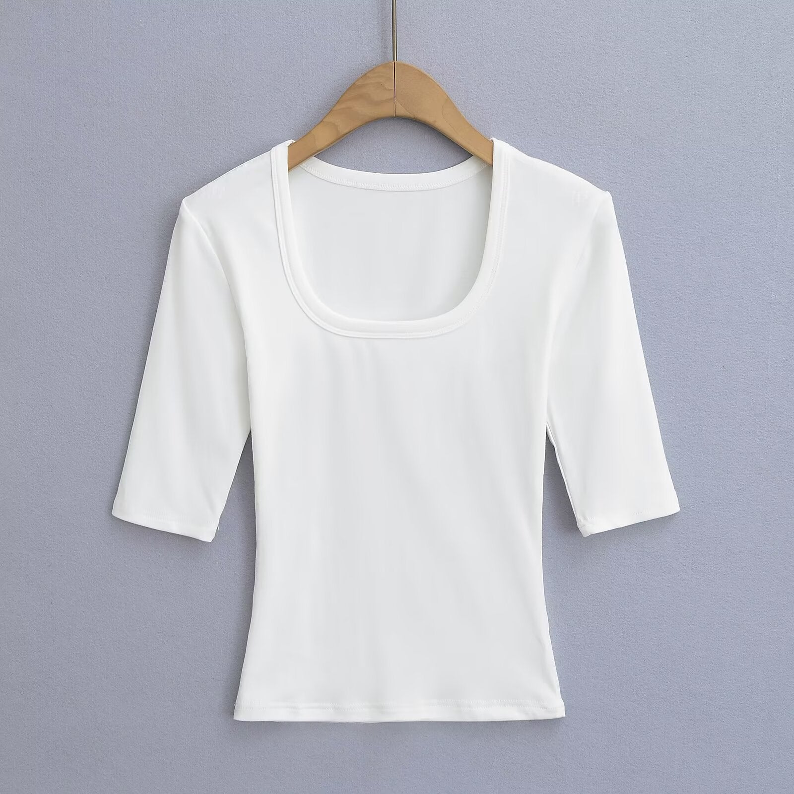 White unisex elastic fitted U-neck lockbone mid-sleeve tee styled casually, lifestyle shot | TeenStylo