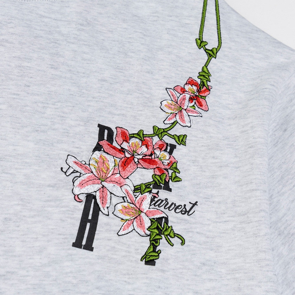 Black vine flower embroidery letter detail on short sleeve t-shirt close-up | TeenStylo