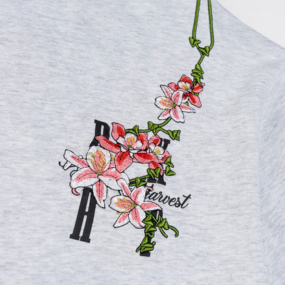Black vine flower embroidery letter detail on short sleeve t-shirt close-up | TeenStylo