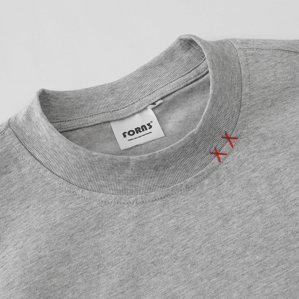 Close-up detail of men's floral gray round neck T-shirt fabric and stitching - TeenStylo