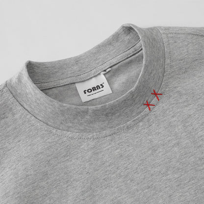 Close-up detail of men's floral gray round neck T-shirt fabric and stitching - TeenStylo