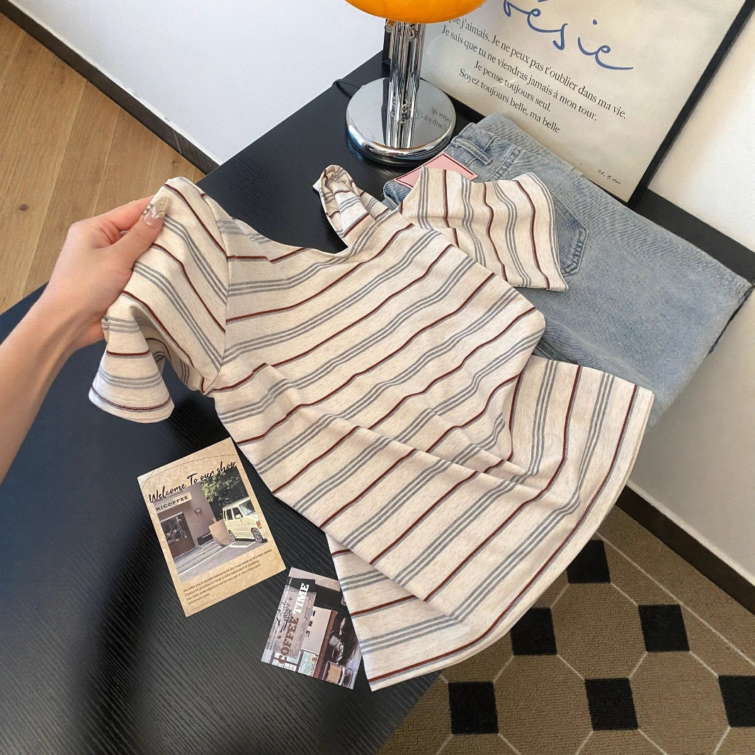 Striped off-shoulder short sleeve tee worn in lifestyle setting, Y2K streetwear style, unisex fashion at TeenStylo