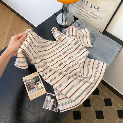 Striped off-shoulder short sleeve tee worn in lifestyle setting, Y2K streetwear style, unisex fashion at TeenStylo