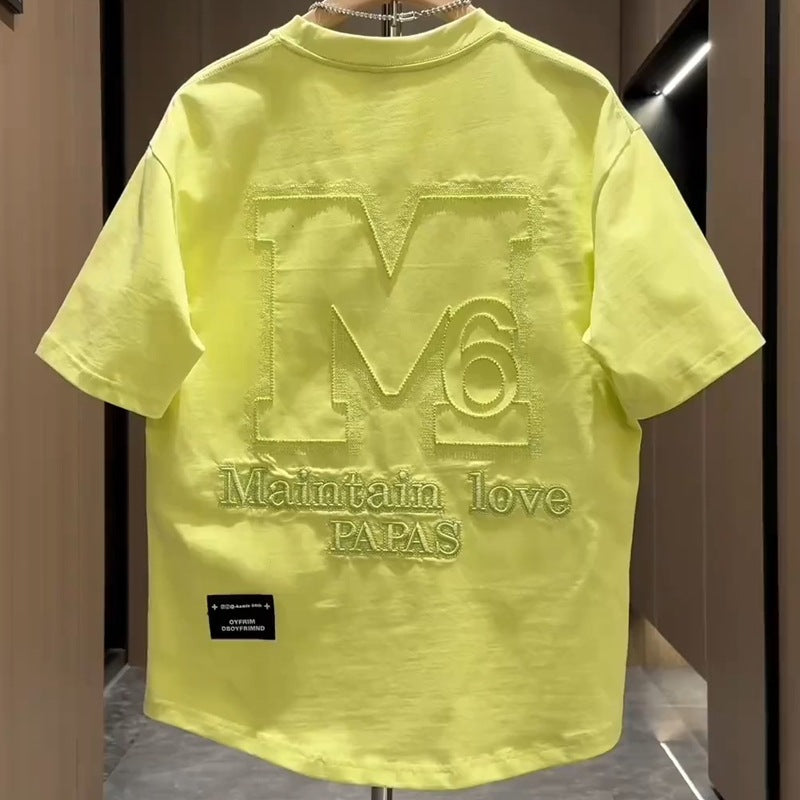 Back view of men's green designer letter M embroidered half top streetwear style TeenStylo