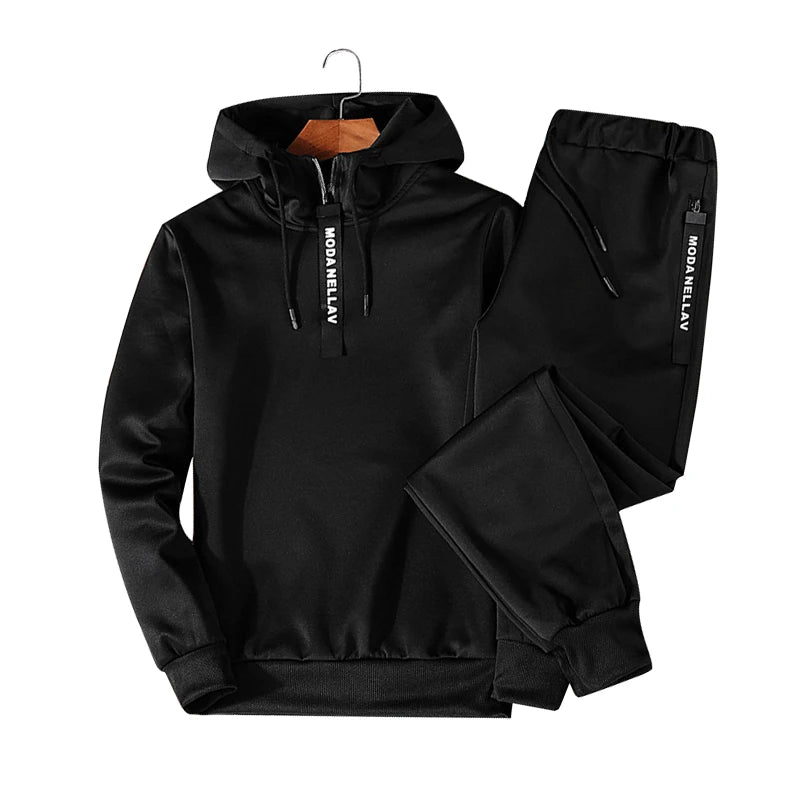 Black men's tracksuit hoodie detail close-up stitching and fabric texture streetwear style TeenStylo