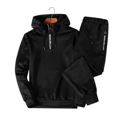 Black men's tracksuit hoodie detail close-up stitching and fabric texture streetwear style TeenStylo